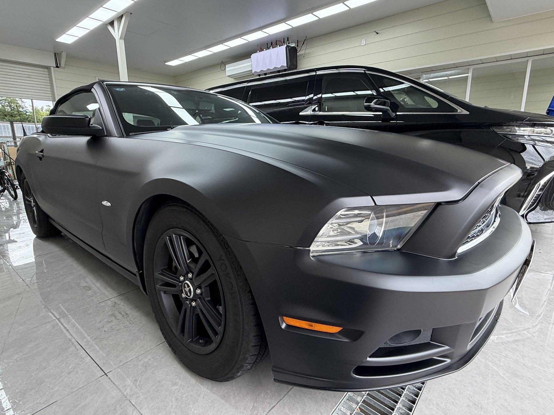 Texture of the Ford Mustang fully wrapped in satin black