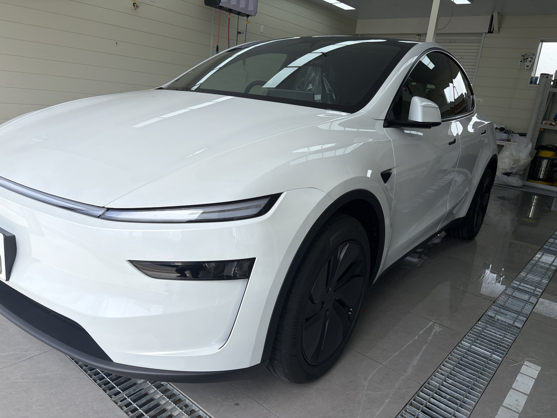 Tesla Model Y before matte clear PPF front angle gloss white